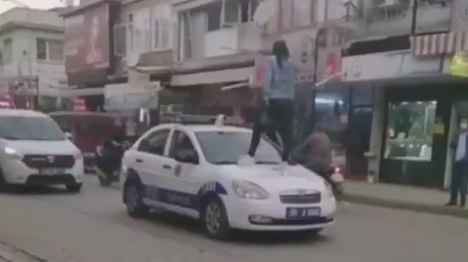 İzmir de tuhaf olay: Genç kız polis aracının üstüne çıktı!